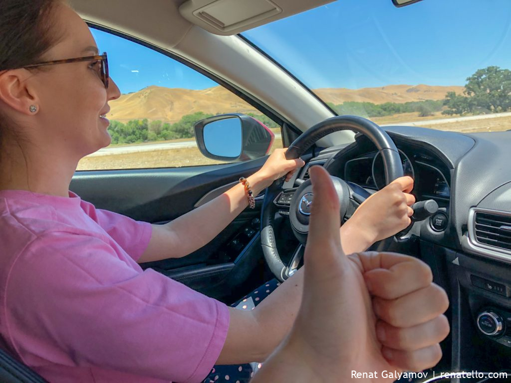 Amina driving a car in California